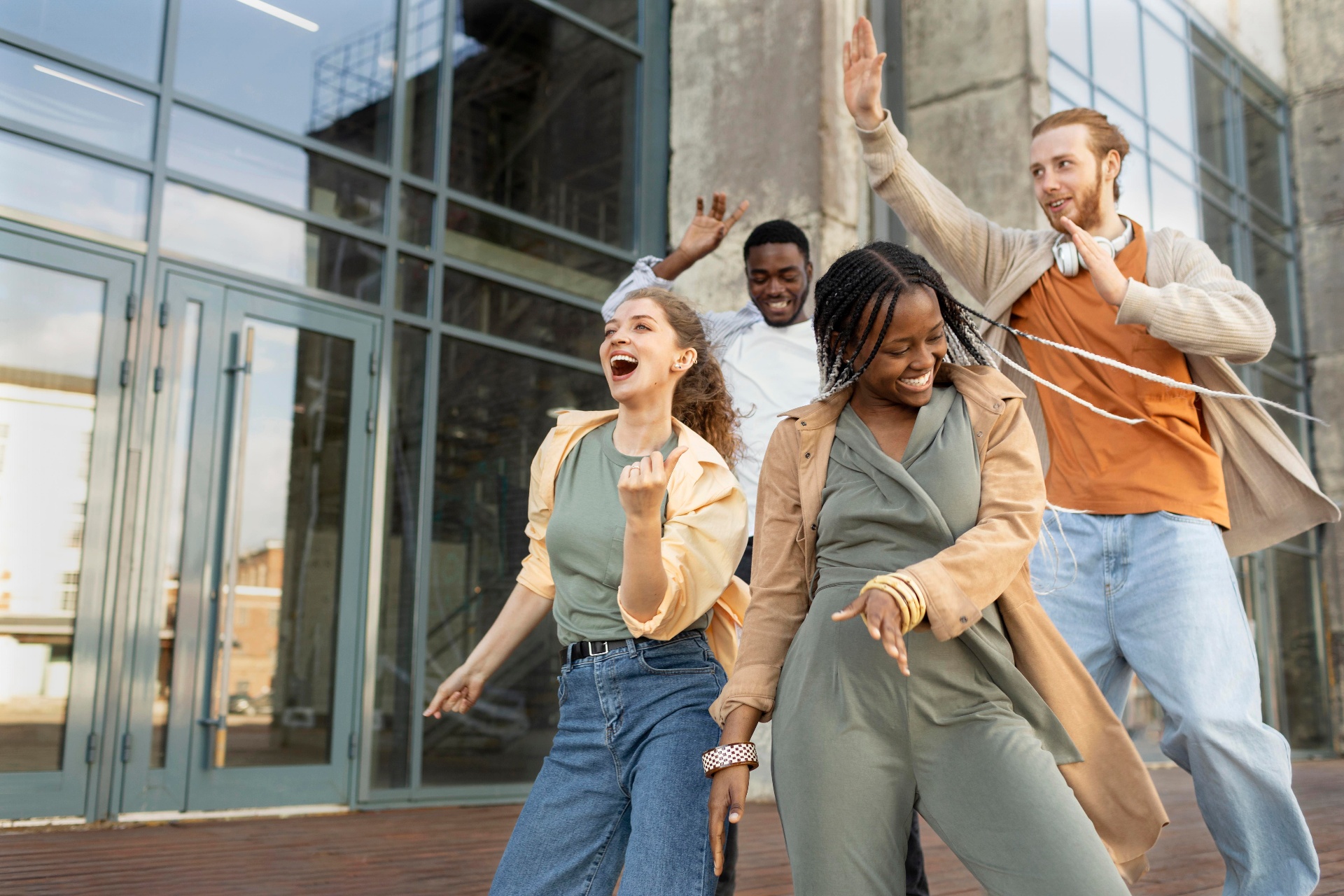 International students celebrating outside a modern European campus building